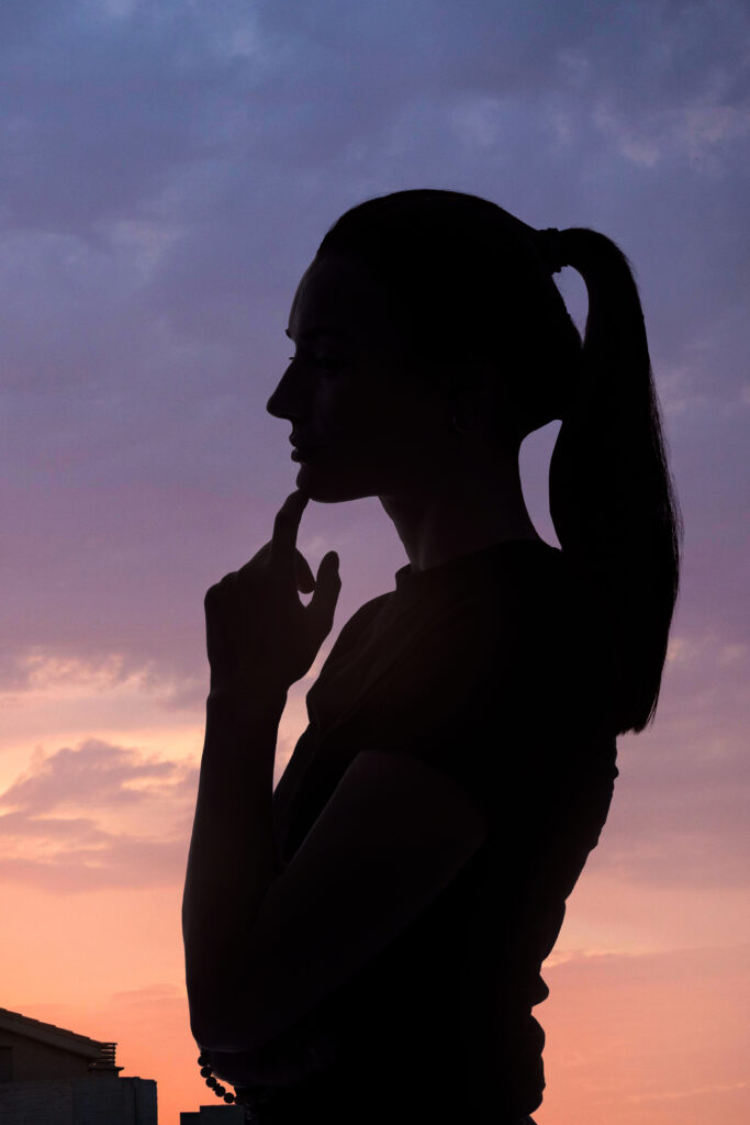 side-view-woman-posing-with-sky-background